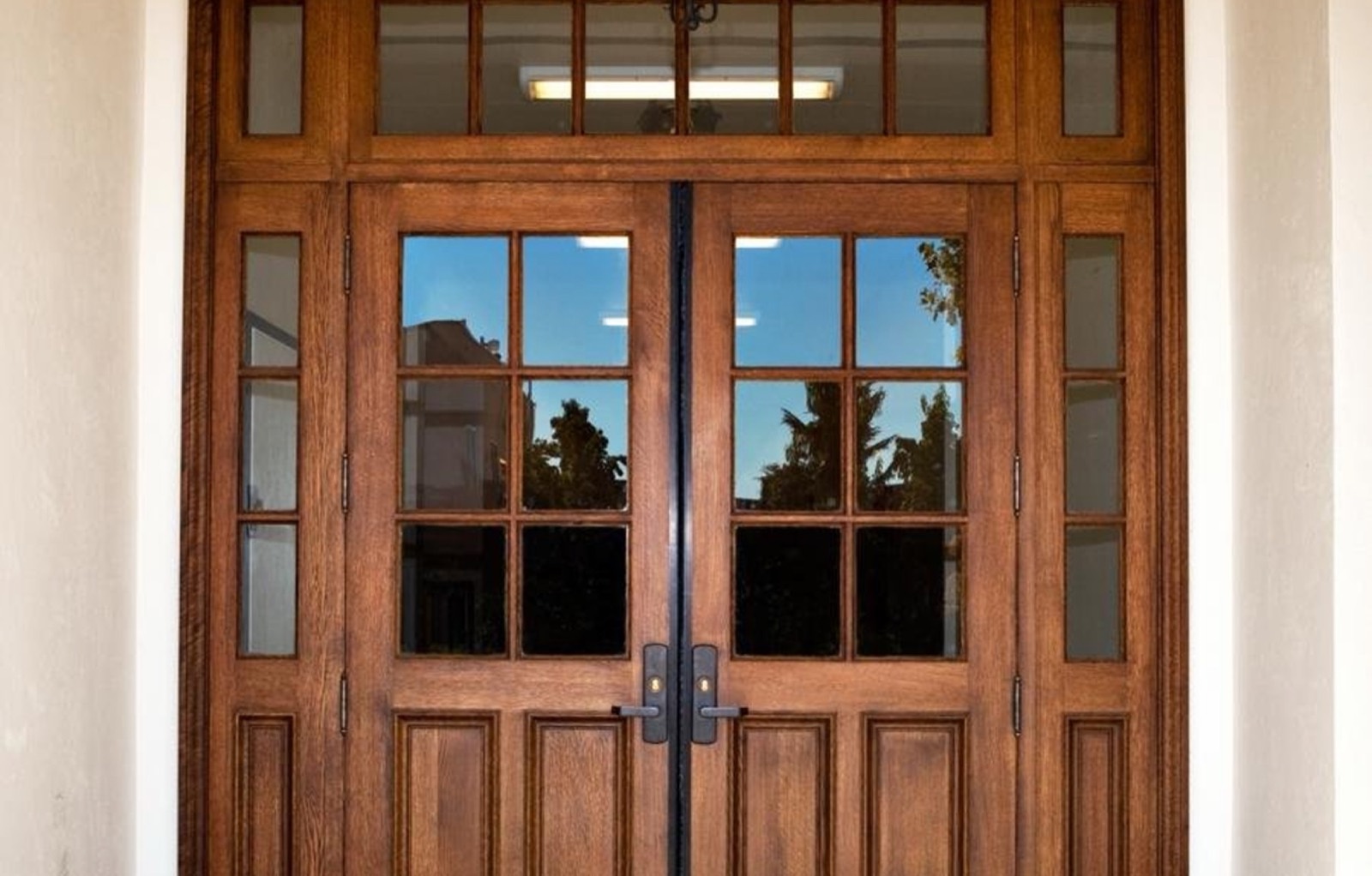 Pair of glazed hardwood entrance doors with sidelights