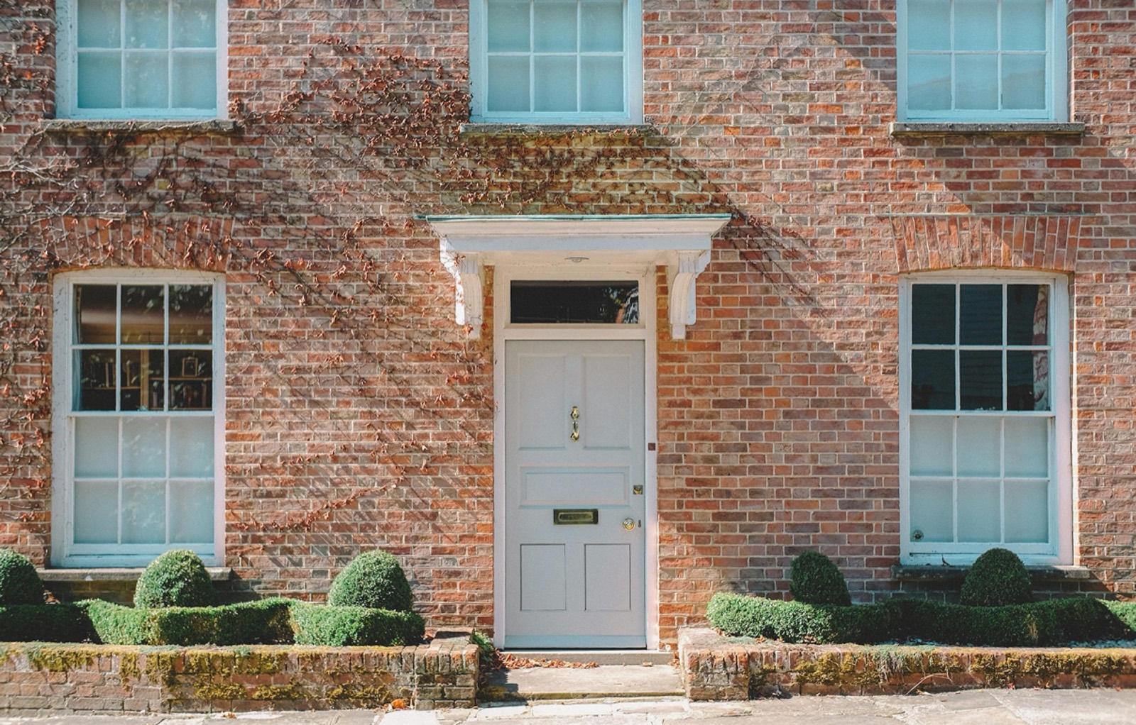 Georgian red-brick house with white timber sash windows