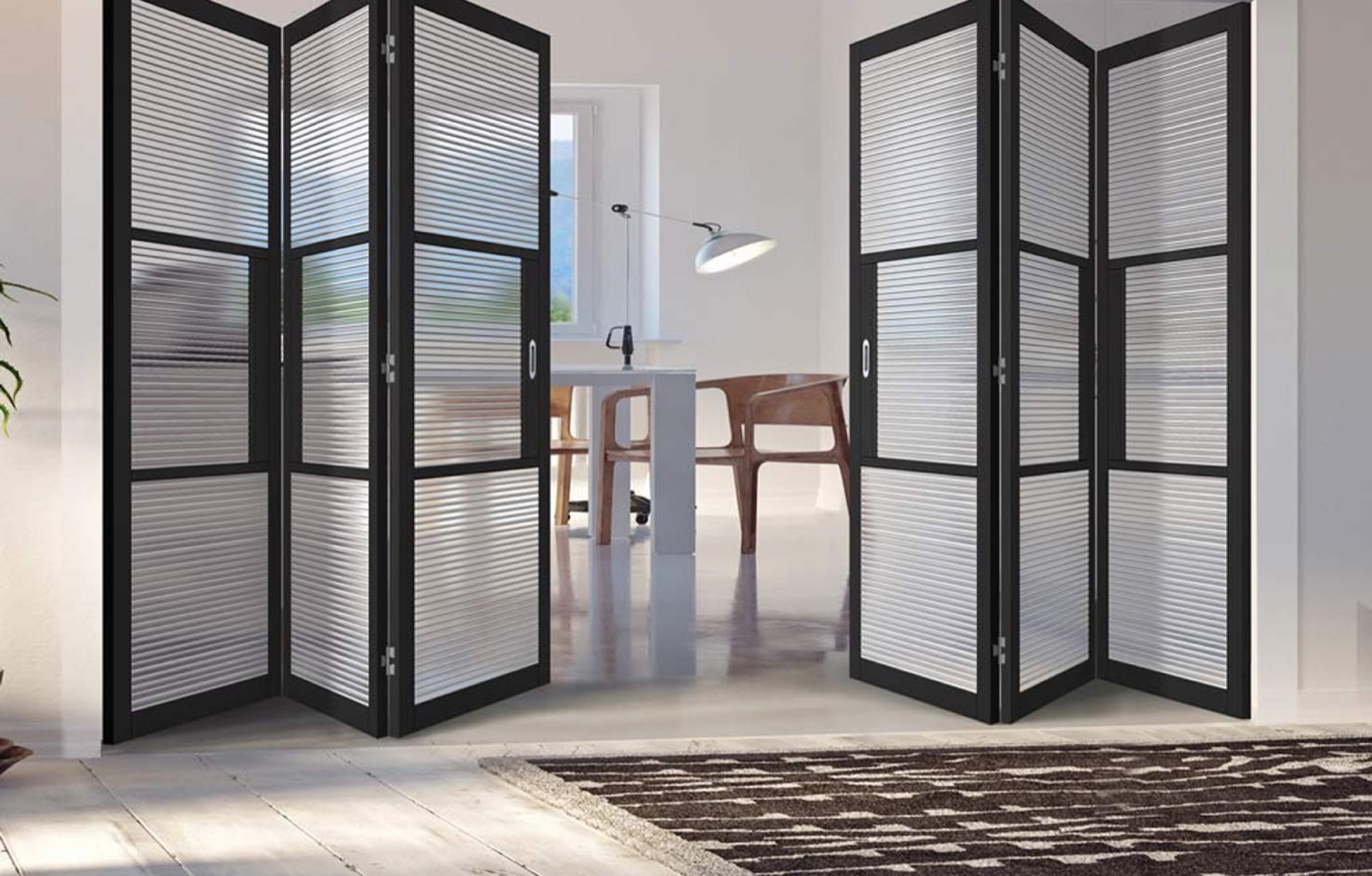 Black-framed glazed folding internal doors in a bright kitchen