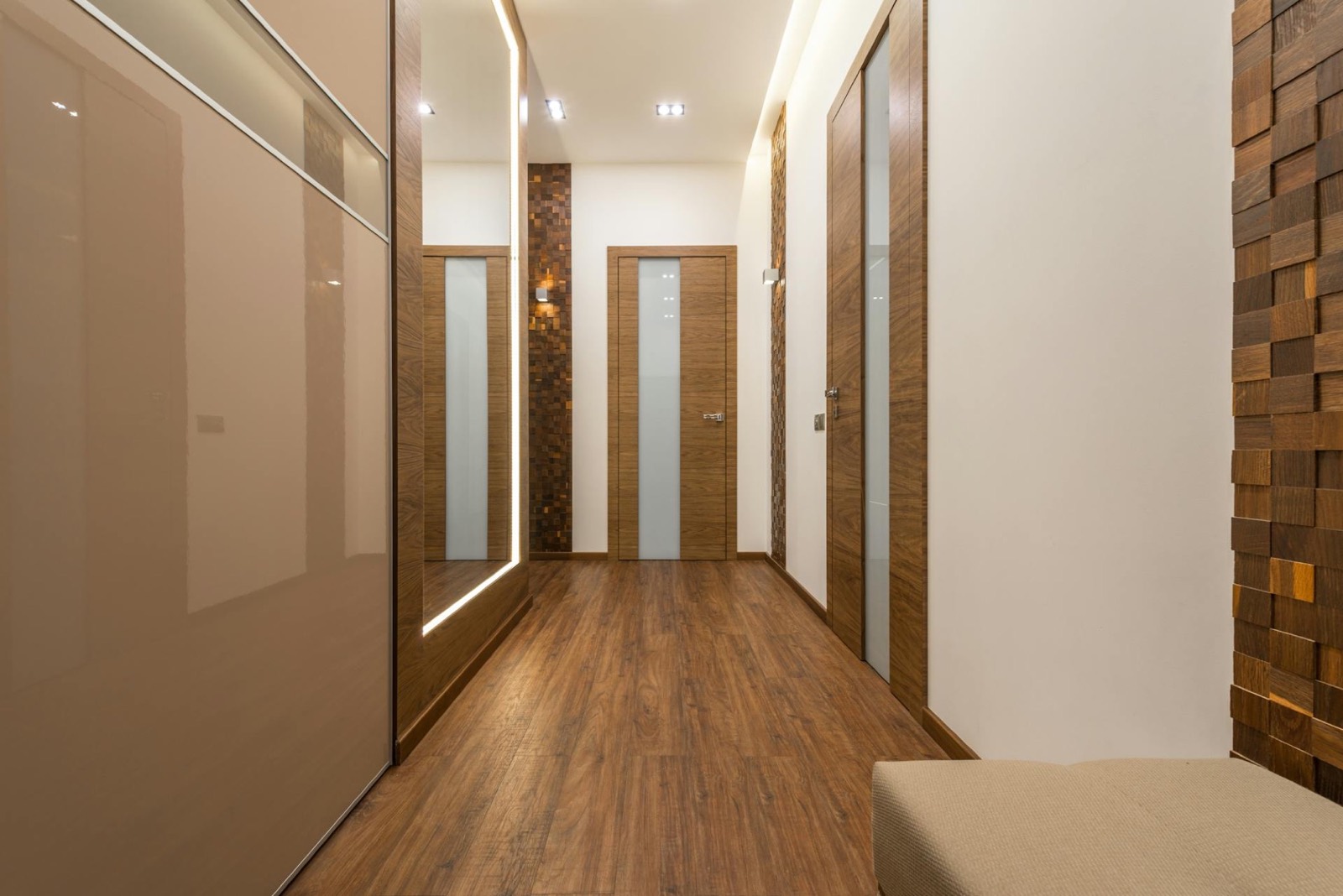 Long hallway lined with flush timber doors